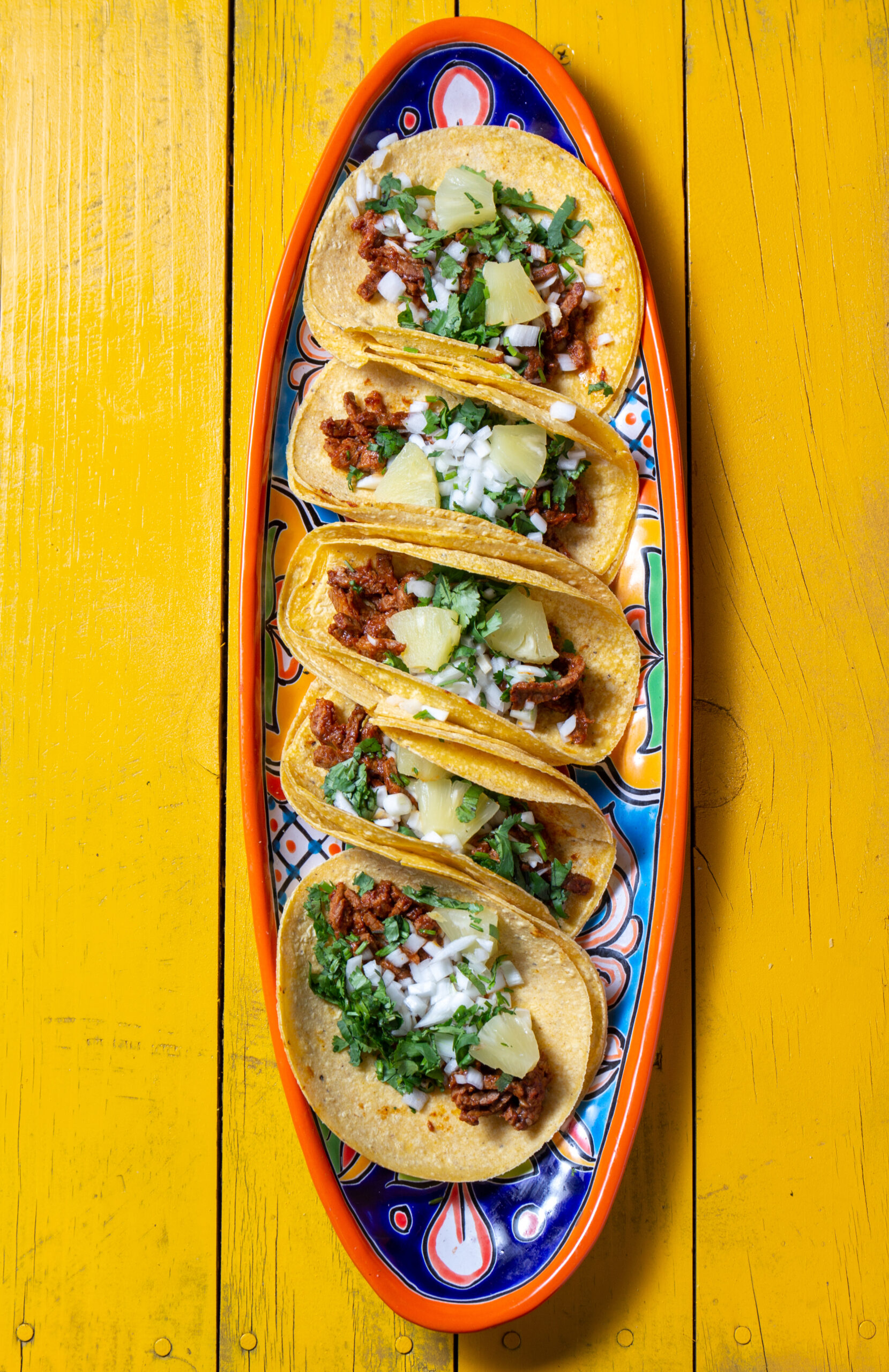 Authentic Taco Works-style tacos served on a plate with garnish.